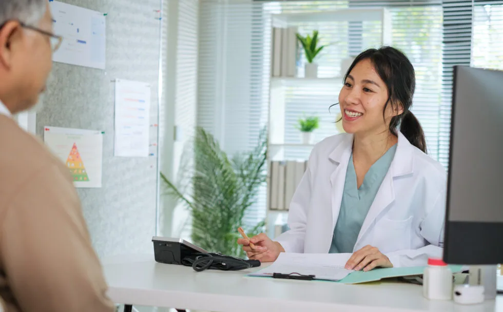 Doctor-Reviewing-Medical-File-While-Interviewing-Elderly-Patient-at-Clinic-or-Hospital-980x608 (1)